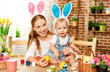 © JenkoAtaman - Happy easter! family mother and baby son paint eggs for holiday Easter
