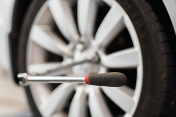 screwdriver and car wheel tire