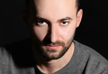 Wall Mural - Portrait of handsome man on black background, closeup