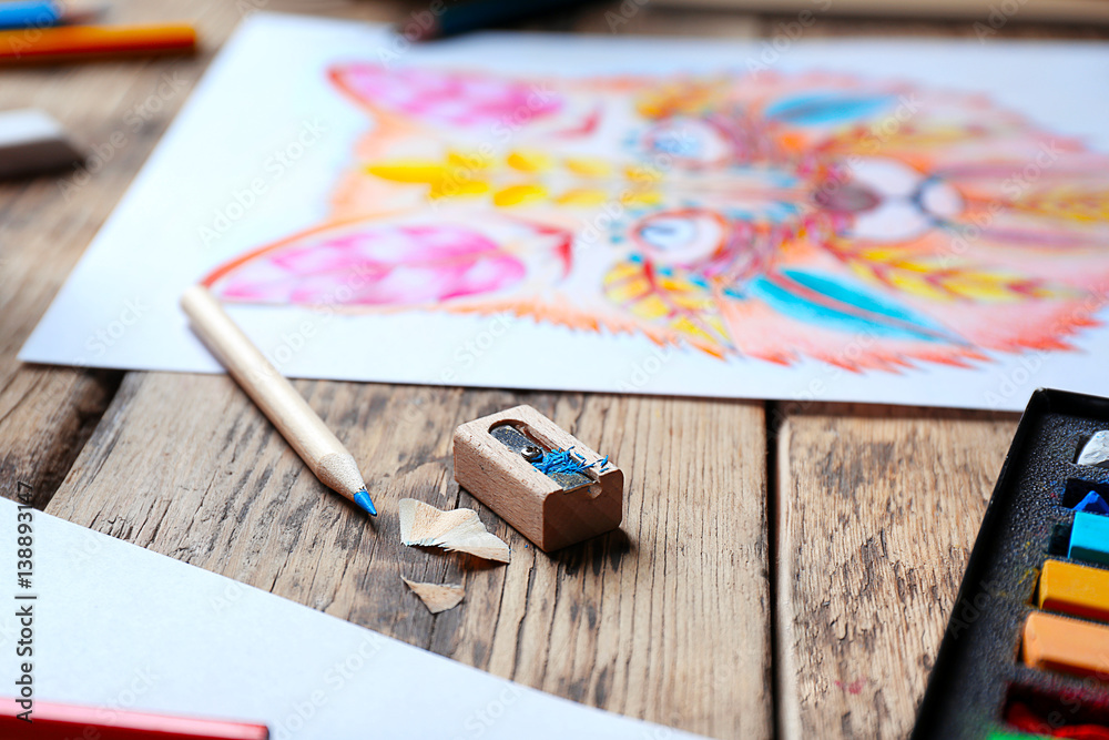 Pencil with sharpener and colouring picture on background