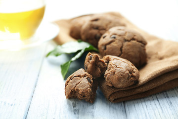 Canvas Print - Delicious coffee cookies and cup of tea on wooden table