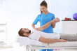 © Africa Studio - Physiotherapist working with patient in clinic