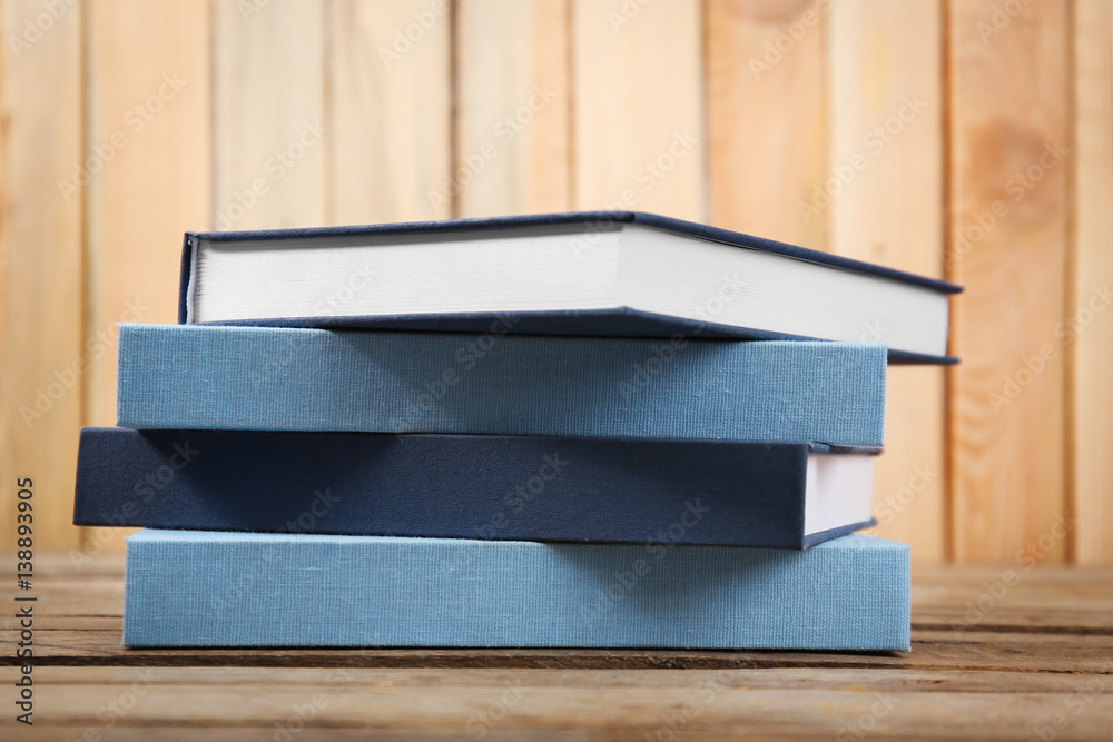 Books stacked on wooden background