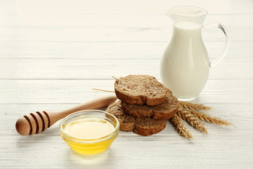 Canvas Print - Composition with milk, honey and bread on wooden background