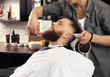 © Africa Studio - Hairdresser shaving client in barbershop