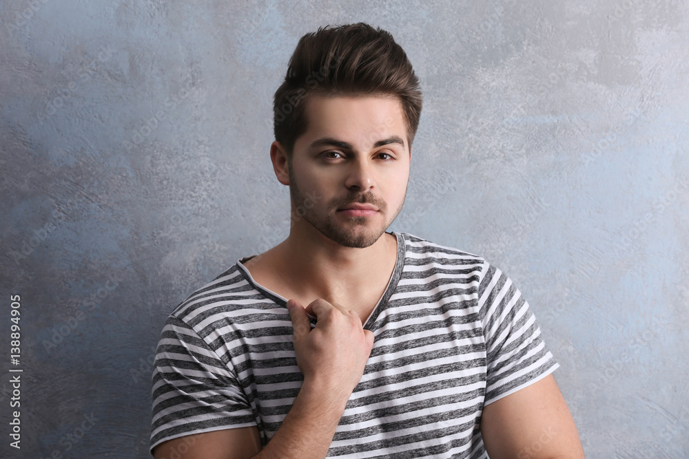 Handsome young man on color background