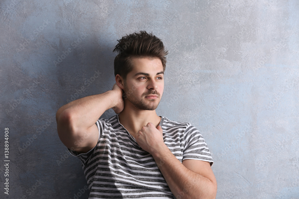 Handsome young man on color background