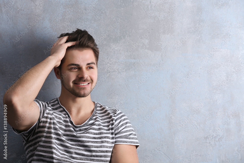 Handsome young man on color background