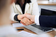 © rogerphoto - Close up of business people shaking hands at meeting or negotiation in the office. Partners are satisfied because signing contract
