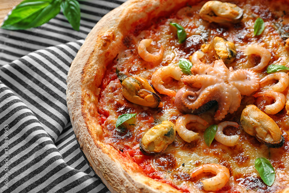 Gourmet pizza with seafood and napkin, closeup