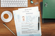 © Africa Studio - Employer workplace with resumes