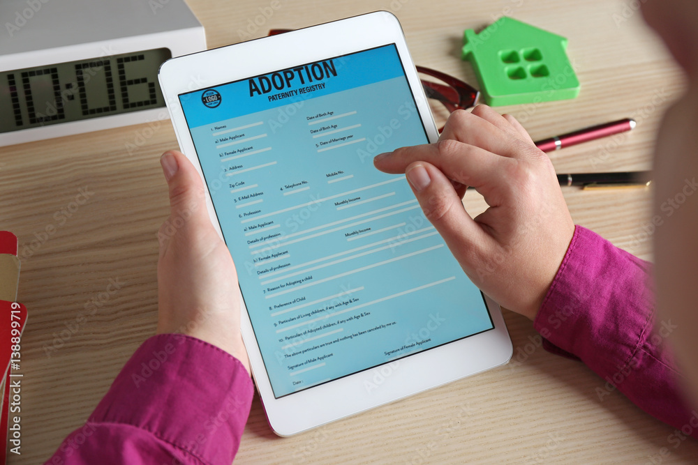 Woman filling adoption paternity registry in tablet