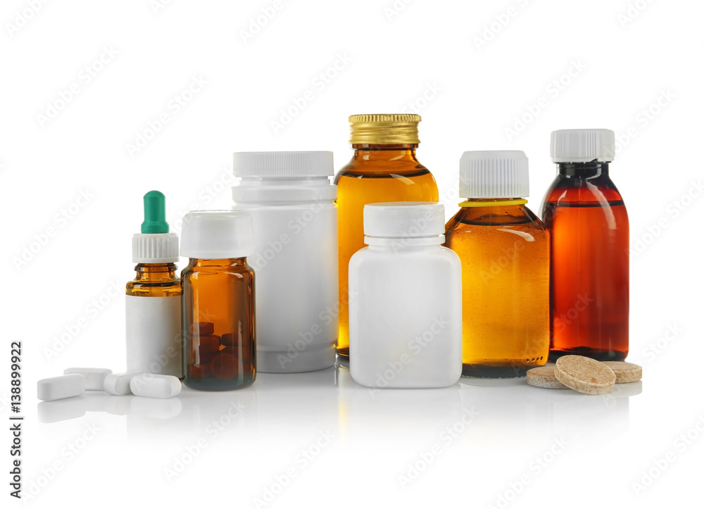 Bottles with cough syrup, pills and medicines isolated on white