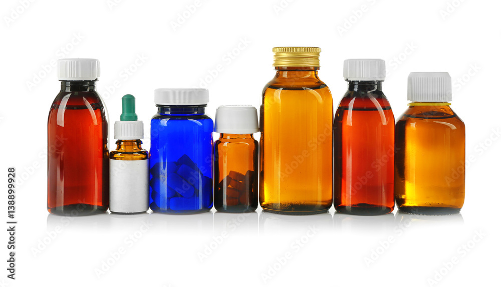 Bottles with cough syrup, pills and medicines isolated on white
