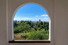 View Through A Window In The World-famous Alhambra In Granada With Beautiful Views Of The Fortress And Granada.