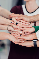 Shot of a group of unrecognizable coworkers' hands in a huddle