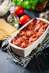 Wall Mural - Hot tasty lasagna with spinach in ceramic casserole dish