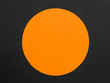 Solid Orange Disc or Circle Against a Black Background