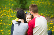 © Andrii Oleksiienko - Closeup portrait of happy family. Little funny girl of 4 years age playing outside with her parents in spring city park. Horizontal color photography.