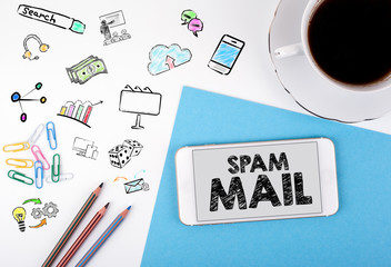 Wall Mural - Spam Mail. Mobile phone and coffee cup on a white office desk.