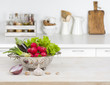 Fresh vegetables on wooden table over blurred kitchen counter interior