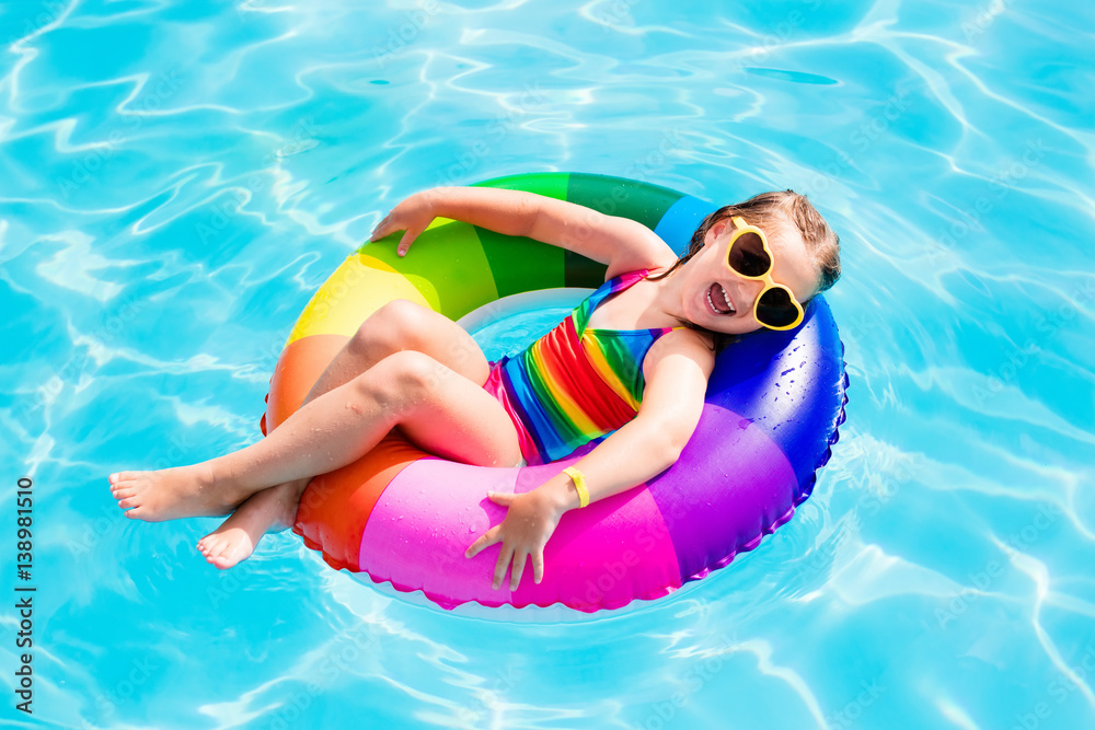 Child with toy ring in swimming pool - obrazy, fototapety, plakaty 