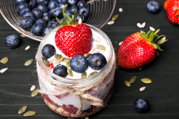 Wall Mural - delicious dessert - yogurt with strawberries and blueberries