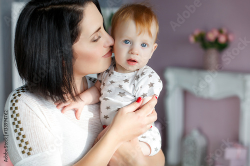 Happy Young Mother A Woman With Black Hair Holding Her Small Son A
