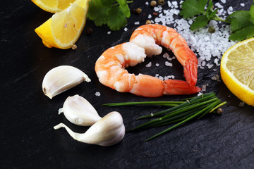 Wall Mural - Delicious sauteed shrimp heart with cajun seasoning and lime on dark stone