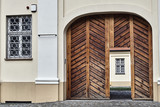 Wooden doors and barred windows in a historic building in Gniezno.
