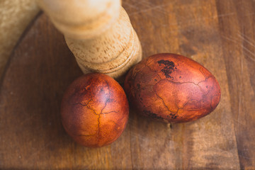 Wall Mural - Easter eggs on wooden background. Painted brown with spots and cracks