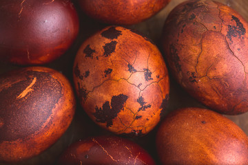 Wall Mural - Easter eggs on wooden background. Painted brown with spots and cracks