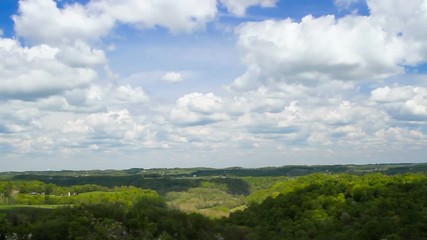 Wall Mural - looping time lapse style video footage features clouds passing over a hilly landscape casting shadow