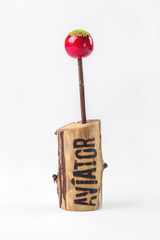 Snack Berry on stick with chips on wooden stand on white backgro