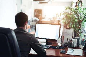 businessman hard at work on a computer in an office