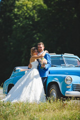 Wall Mural - Newlyweds at Blue Cabriolet