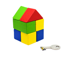 Close up of color toy blocks home model and key. Mortgage, investment, real estate and property concept.