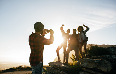 Wall Mural - group of young friends hiking on mountain