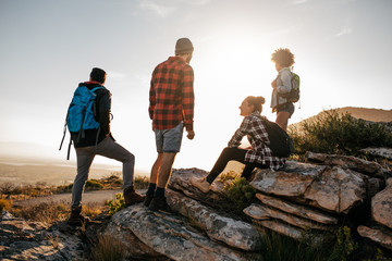 Wall Mural - group of hikers on top of hill and enjoying view