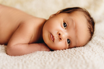 newborn baby lying in a crib