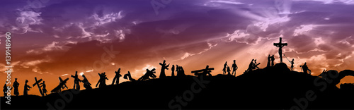 Fotografía Way of the cross or stations of the cross silhouettes of Jesus Christ carrying his cross on Calvary hill, with cloudy dark sky and sun light rays