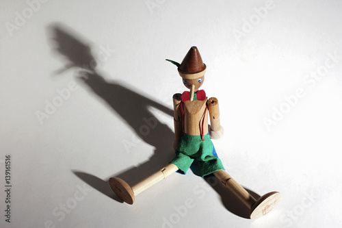 Wooden Pinocchio doll isolated on white background.