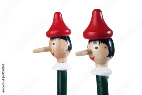 Wooden Pinocchio doll isolated on white background.