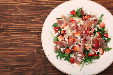 Wall Mural - Arugula salad with strawberries, feta cheese, prosciutto, parmes