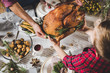 © LIGHTFIELD STUDIOS - Father and son holding roasted turkey