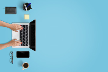 Leinwandbilder - Laptop, smart phone and office supplies with free space for text. Top view of modern blue desk.