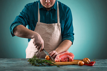 Poster - Butcher cutting pork meat on kitchen