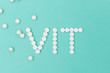 White Pills Forming the Word Vit