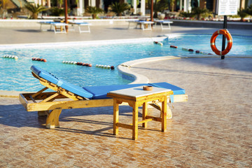 Blue sun chair on the background of  swimming pool