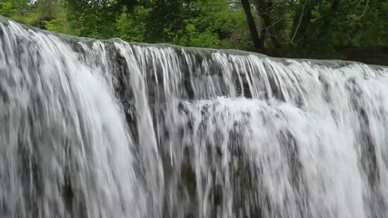 Wall Mural - Seamlessly looping video footage features water pouring over the edge of an Upper Cataract Falls, a waterfall in rural Owen County, Indiana.